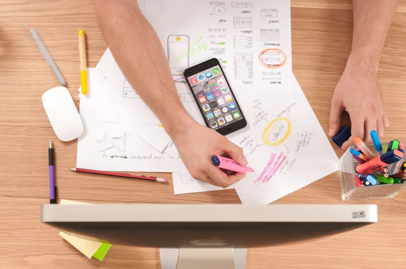 Strategist marking up keyword research notes at a desk