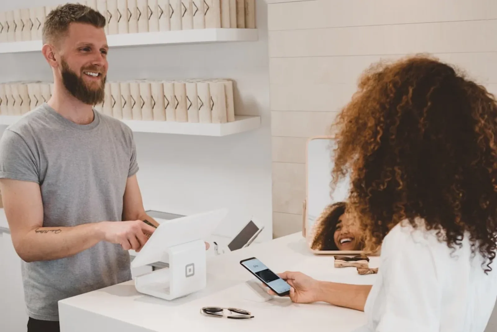 Shopper paying at the counter of a boutique retail store
