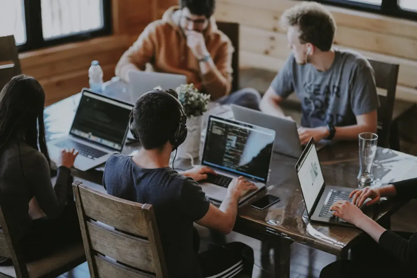 Team working together on laptops around a table